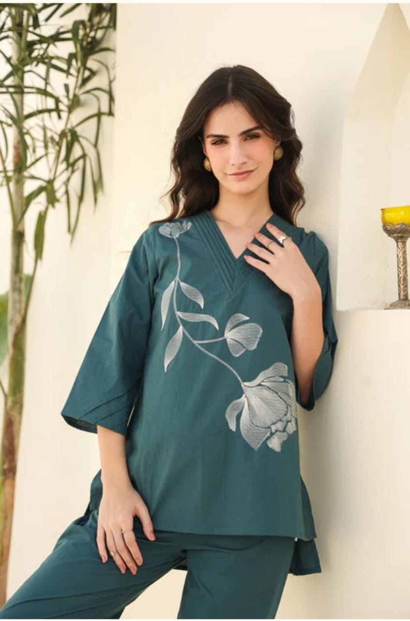 Trendy teal co-ord set with subtle floral print. Comfortable wide-leg pants paired with stylish top make it perfect for casual outings.